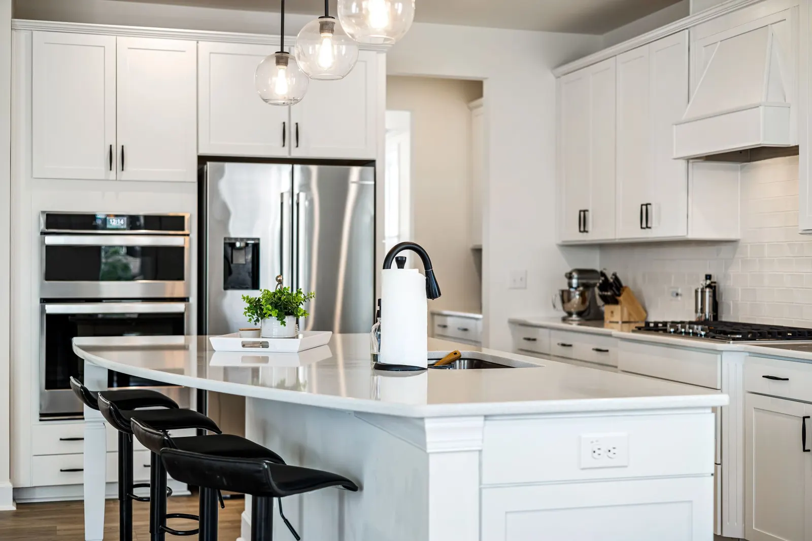 White kitchen with pendant lights over an island
