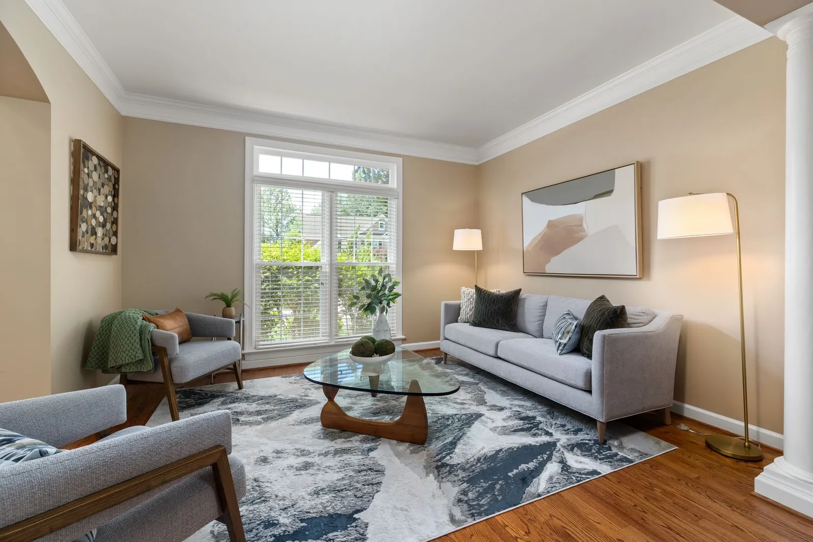Bright living room with grey sofas and a glass coffee table